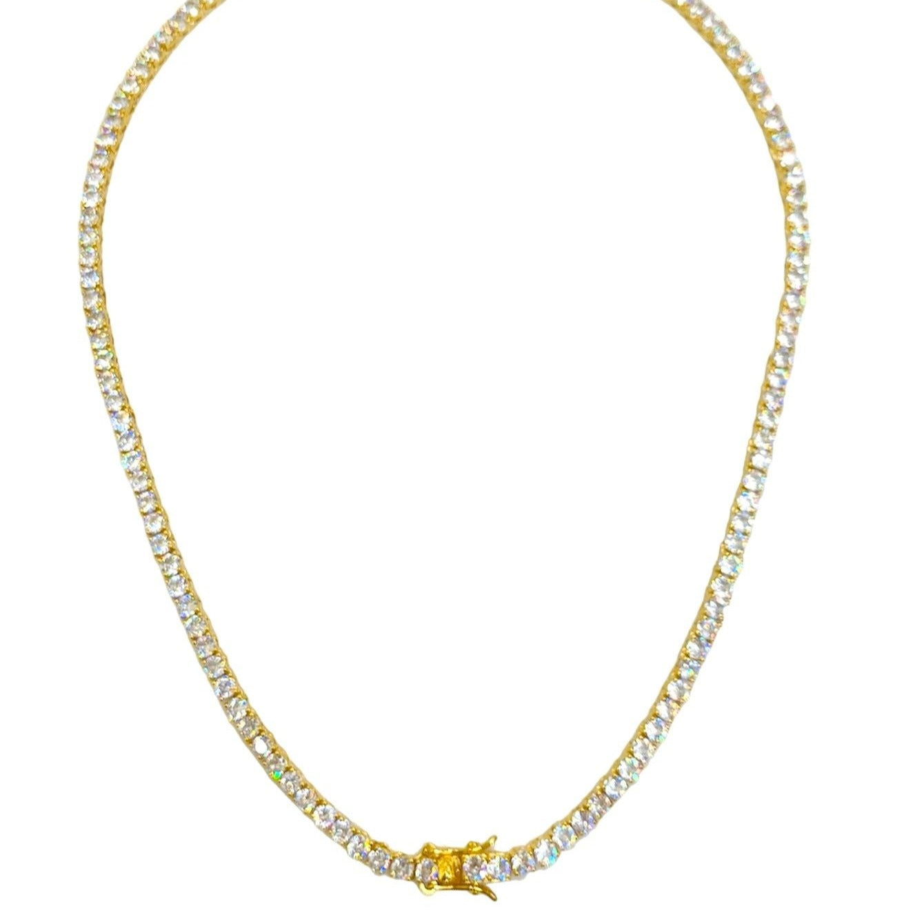 This close-up of a sparkling tennis necklace with shimmering zircon stones, a gold-plated finish, and a sleek 3mm width showcases its radiant elegance and timeless appeal. 
Perfect for both casual and formal occasions, this luxurious piece adds a touch of sophistication to any outfit. 