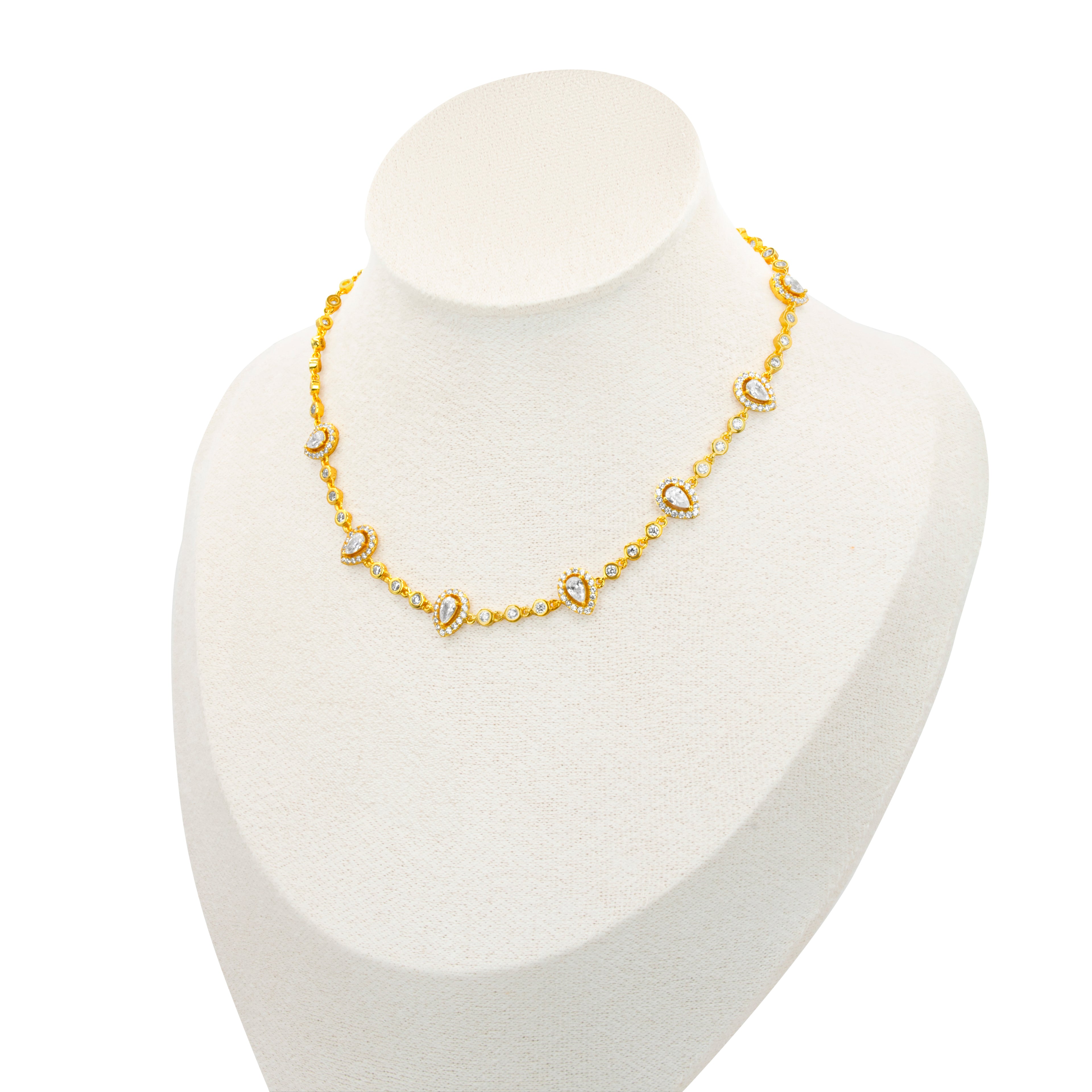 Almond choker by Selsela features a gold necklace adorned with small 
pearl-like beads and elegant paisley-shaped pendants, beautifully displayed on a white mannequin bust.