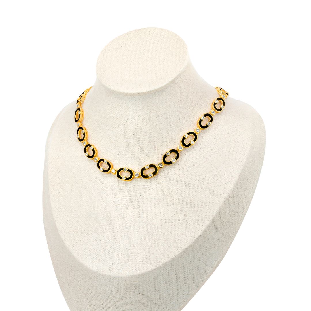 The Neera Choker necklace , with its bold circular links, elegantly contrasts against a white mannequin bust from Selsela.